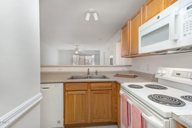 a kitchen with a sink a stove and cabinets