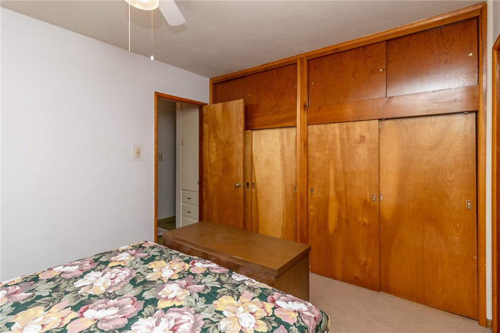 630 Acoma Street Needles, CA 92363 - Photo 23 of 60 a bedroom with a bed and a table in it