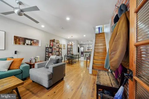 a living room with furniture and a wooden floor