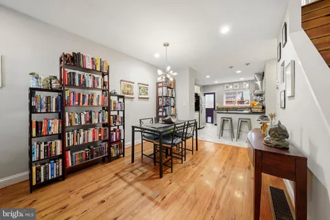 a living room with lots of furniture and a book shelf