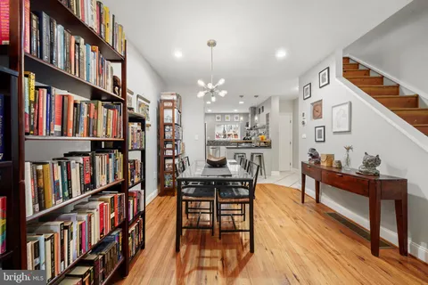 a view of a workspace with furniture book shelf and wooden floor
