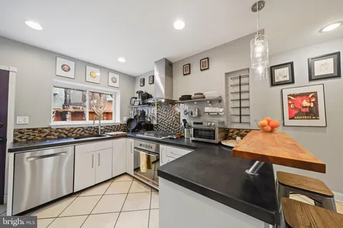 a kitchen with stainless steel appliances granite countertop a sink and cabinets