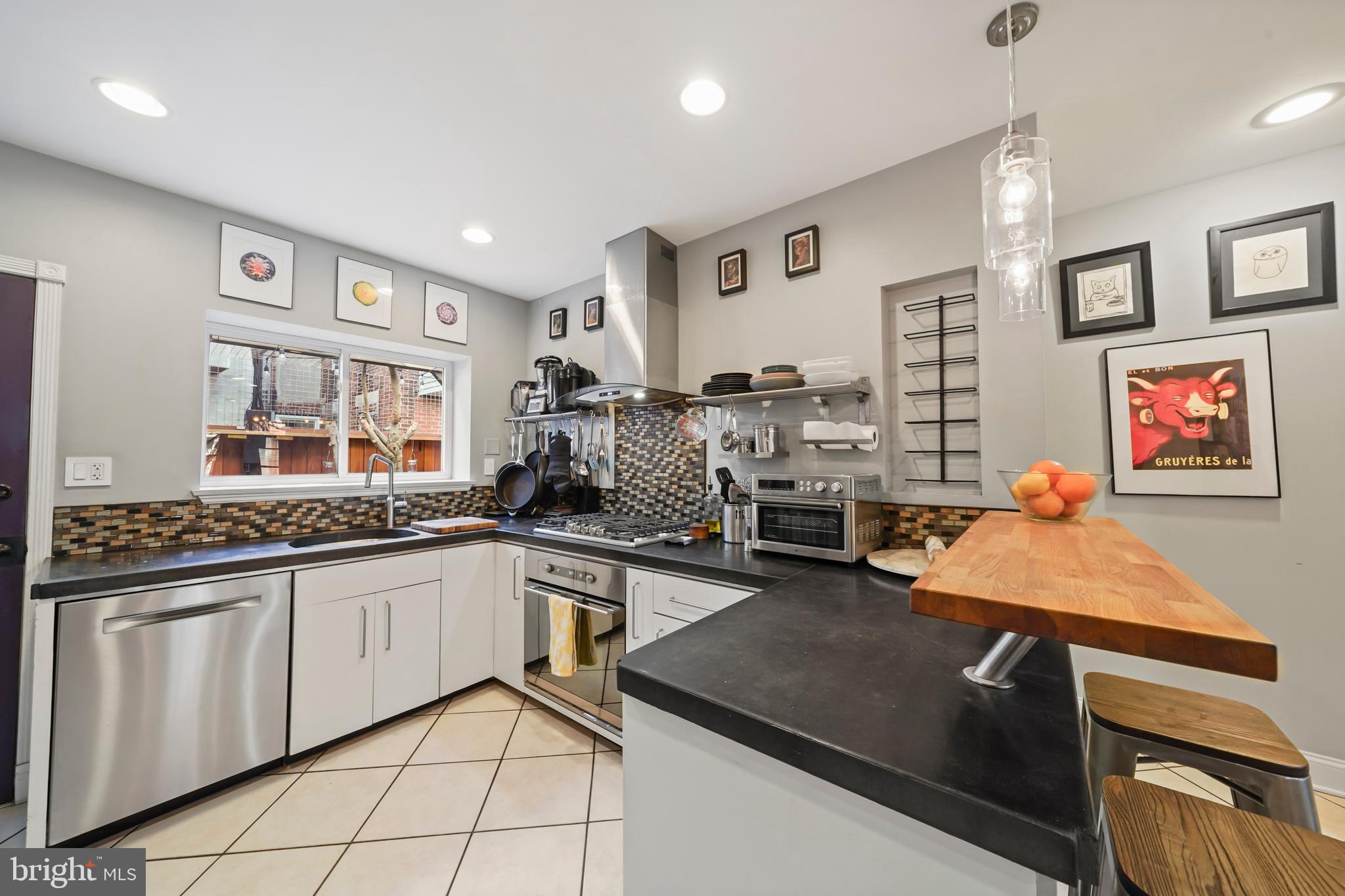 1318 South Alder Street Philadelphia, PA 19147 - Photo 17 of 39 a kitchen with stainless steel appliances granite countertop a sink and cabinets