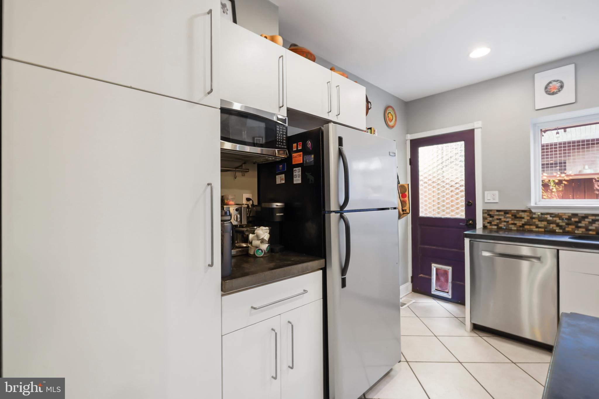 1318 South Alder Street Philadelphia, PA 19147 - Photo 20 of 39 a kitchen with stainless steel appliances granite countertop a refrigerator and a stove top oven
