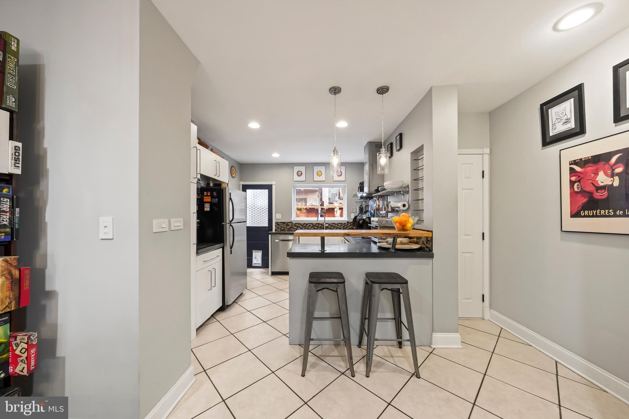 1318 South Alder Street Philadelphia, PA 19147 - Photo 21 of 39 a kitchen with stainless steel appliances granite countertop a refrigerator and a stove top oven