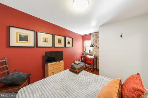 a bedroom with a bed and a chair