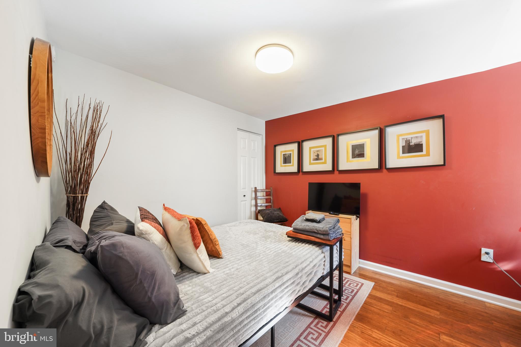1318 South Alder Street Philadelphia, PA 19147 - Photo 26 of 39 a bedroom with a bed and wooden floor