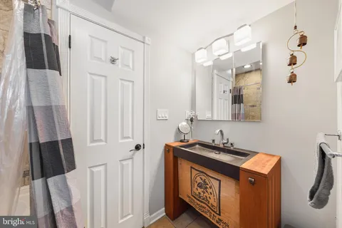 a bathroom with a sink a mirror and a shower