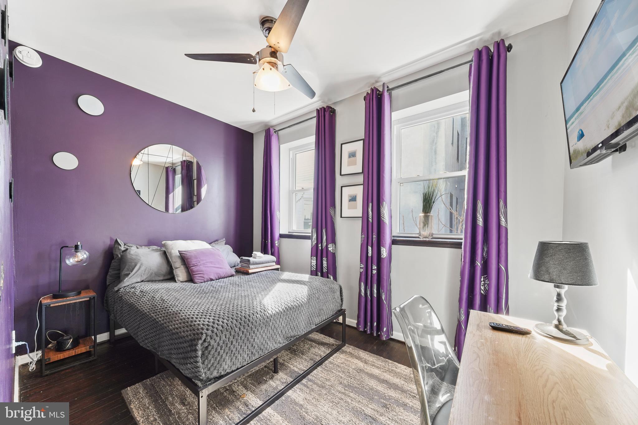 1318 South Alder Street Philadelphia, PA 19147 - Photo 30 of 39 a bedroom with a bed and a lamp