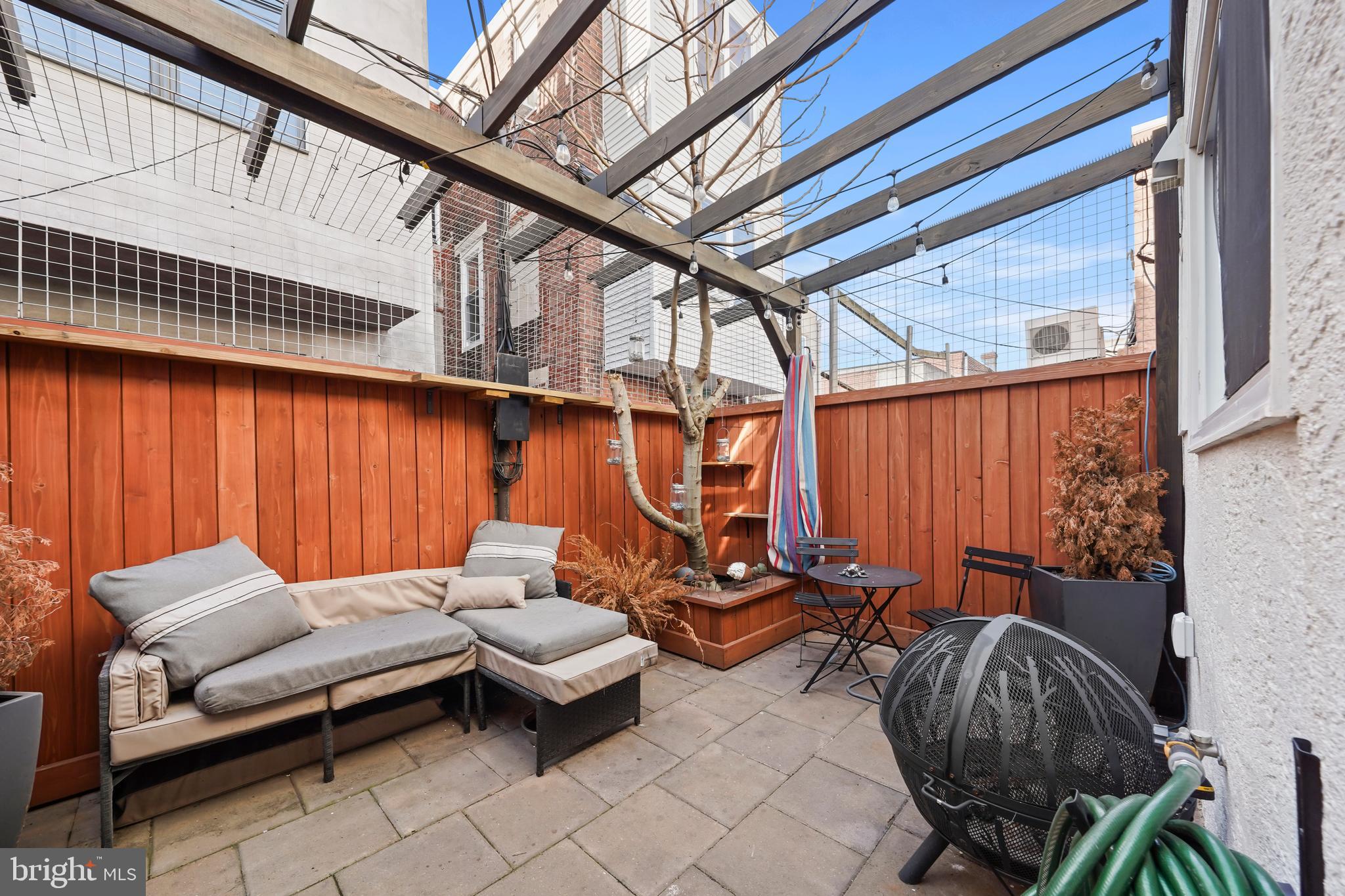1318 South Alder Street Philadelphia, PA 19147 - Photo 33 of 39 a backyard of a house with outdoor seating