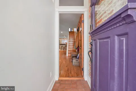 a view of a hallway with wooden floor and entryway