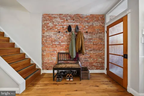 a view of a livingroom with wooden floor and furniture