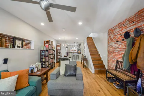 a living room with furniture and a book shelf