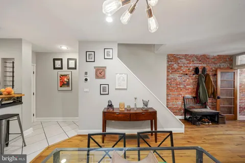 a living room with furniture a flat screen tv and a table