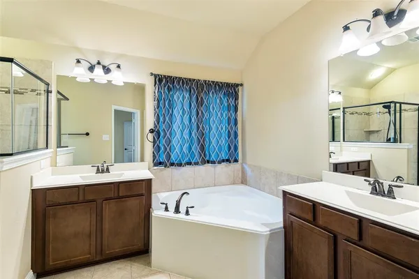 a bathroom with a sink double vanity and a mirror