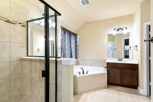 a bathroom with a bathtub and shower