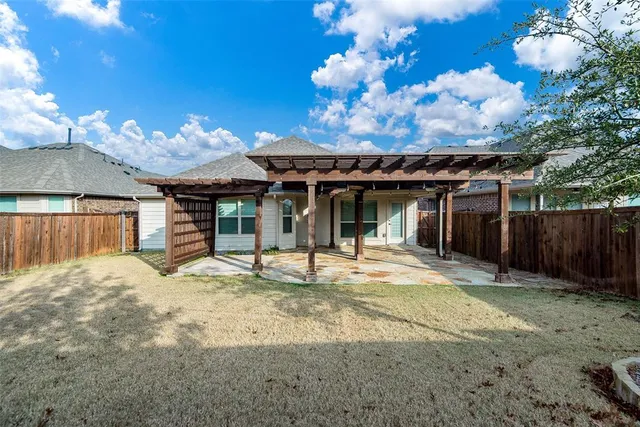 a view of a house with a large window and a yard