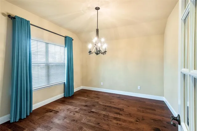 a view of a chandelier fan and entryway