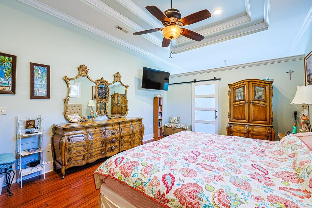 232 Waterfall Circle Little River, SC 29566 - Photo 13 of 40 Bedroom with dark wood-style floors, ceiling fan, and crown molding