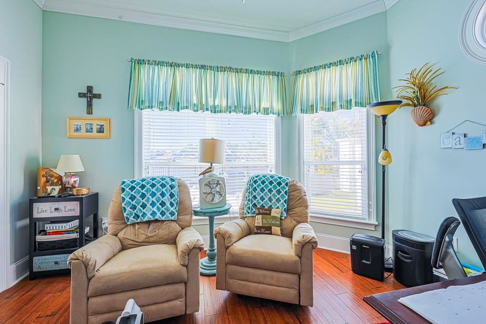 232 Waterfall Circle Little River, SC 29566 - Photo 15 of 40 Living area with wood-type flooring, ornamental molding, and healthy amount of natural light
