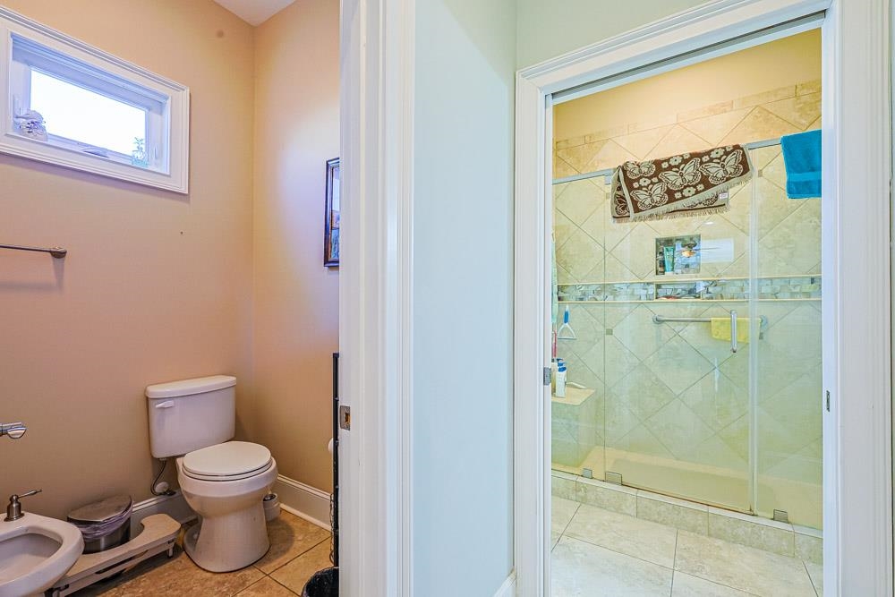 232 Waterfall Circle Little River, SC 29566 - Photo 19 of 40 Bathroom featuring a stall shower, a bidet, and light tile patterned flooring