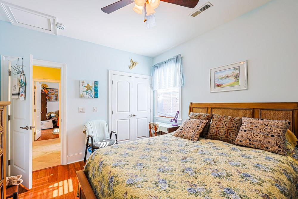 232 Waterfall Circle Little River, SC 29566 - Photo 22 of 40 Bedroom featuring wood finished floors, a closet, a ceiling fan, and attic access