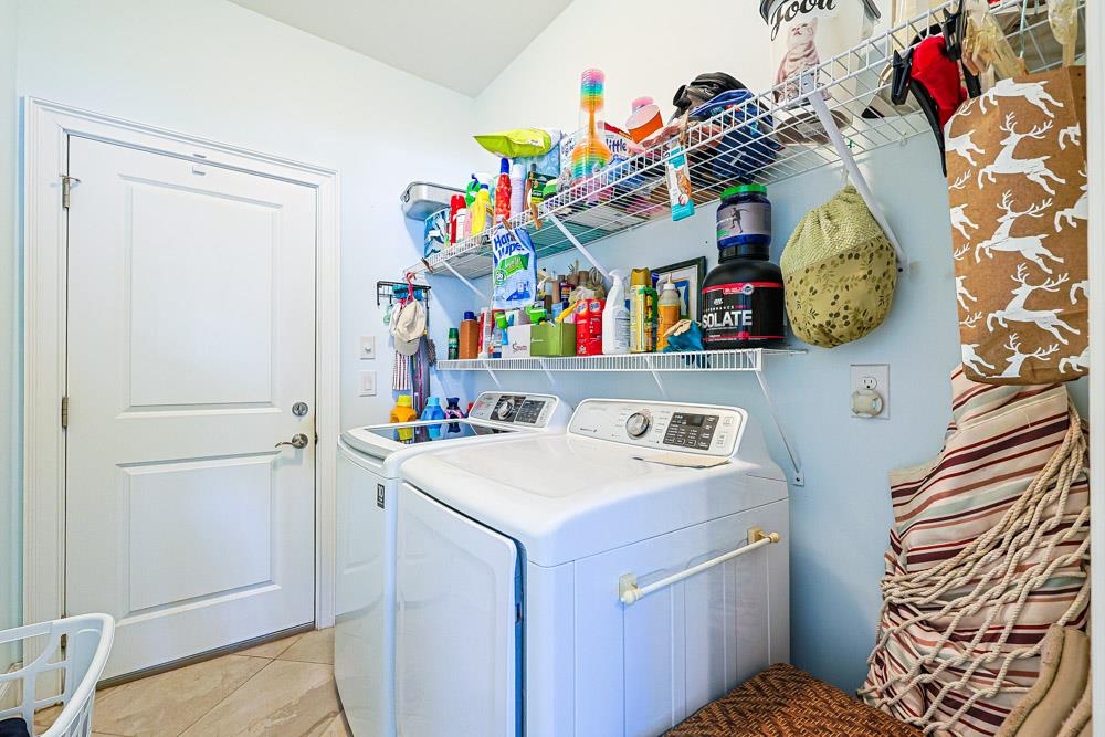 232 Waterfall Circle Little River, SC 29566 - Photo 27 of 40 Laundry room with washer and dryer and light tile patterned flooring