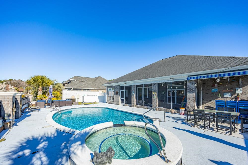 232 Waterfall Circle Little River, SC 29566 - Photo 3 of 40 View of swimming pool featuring a patio, a pool with connected hot tub, outdoor dining space, and an outdoor hangout area