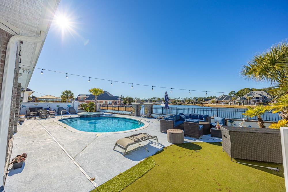 232 Waterfall Circle Little River, SC 29566 - Photo 30 of 40 View of pool featuring outdoor lounge area, a patio, a pool with connected hot tub, and a fenced backyard