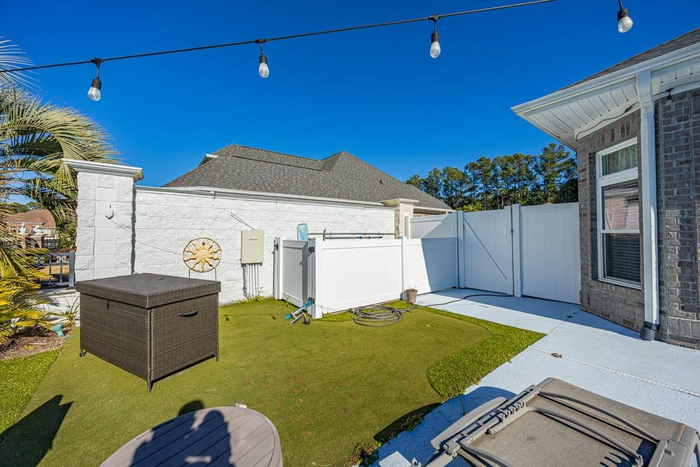 232 Waterfall Circle Little River, SC 29566 - Photo 31 of 40 Fenced backyard featuring putting green and firepit area