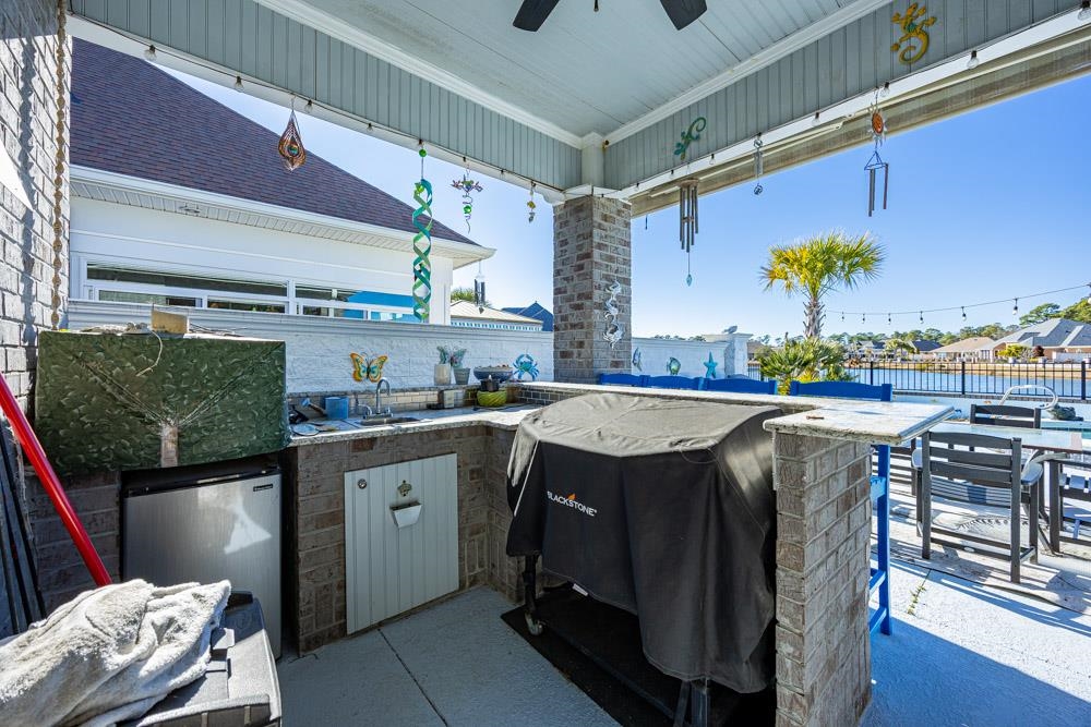 232 Waterfall Circle Little River, SC 29566 - Photo 33 of 40 Covered patio and outdoor kitchen area with bar seating