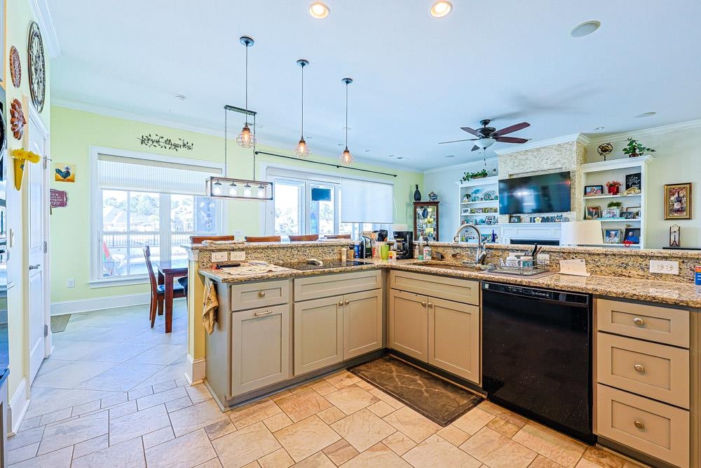 232 Waterfall Circle Little River, SC 29566 - Photo 39 of 40 Kitchen with black dishwasher, ornamental molding, decorative light fixtures, light stone countertops, and open floor plan