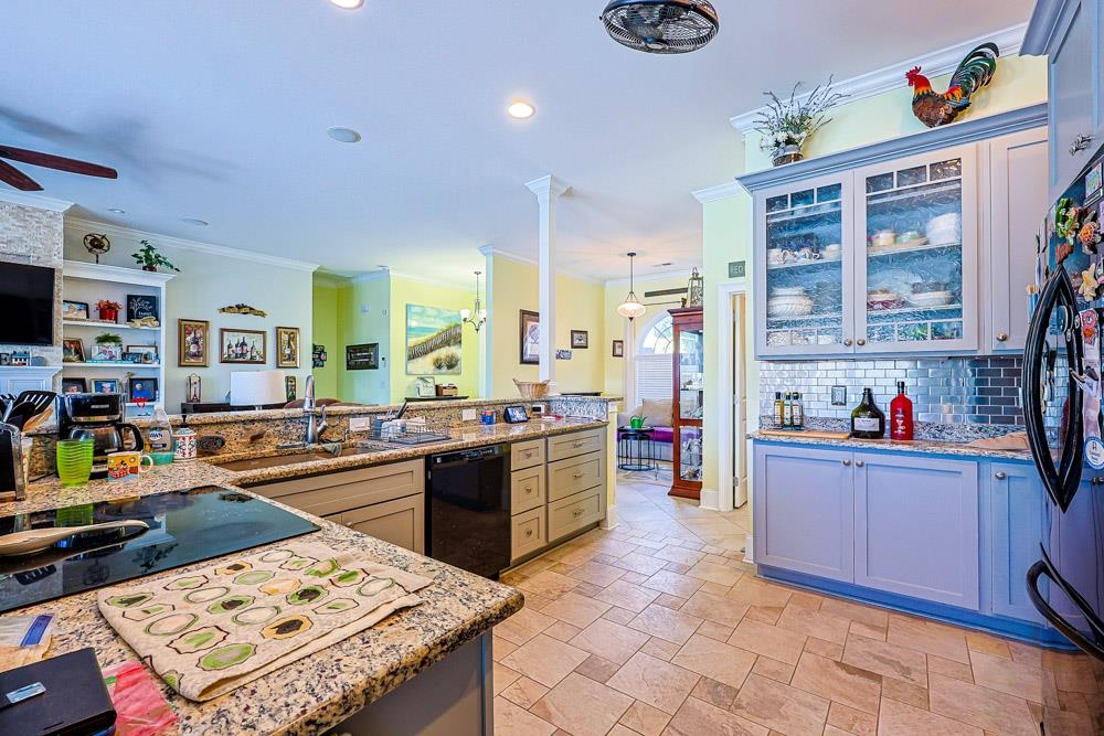 232 Waterfall Circle Little River, SC 29566 - Photo 40 of 40 Kitchen with black dishwasher, freestanding refrigerator, ornamental molding, glass insert cabinets, and open floor plan