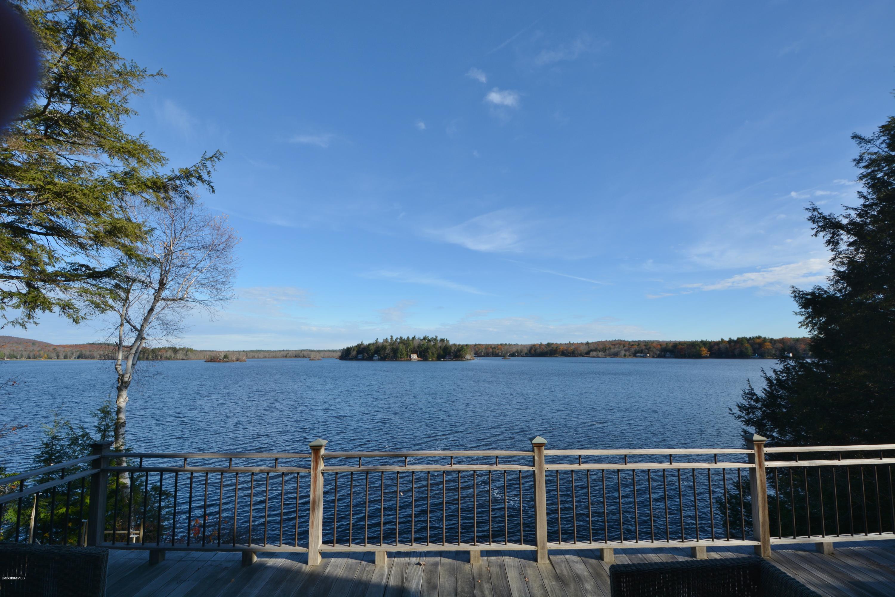 a view of balcony with wooden floor and lake view