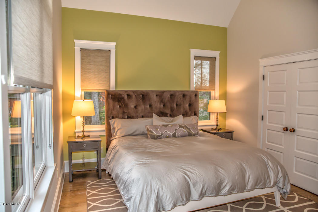 66 Mallard Road Otis, MA 01029 - Photo 21 of 26 a bedroom with a bed and lamps
