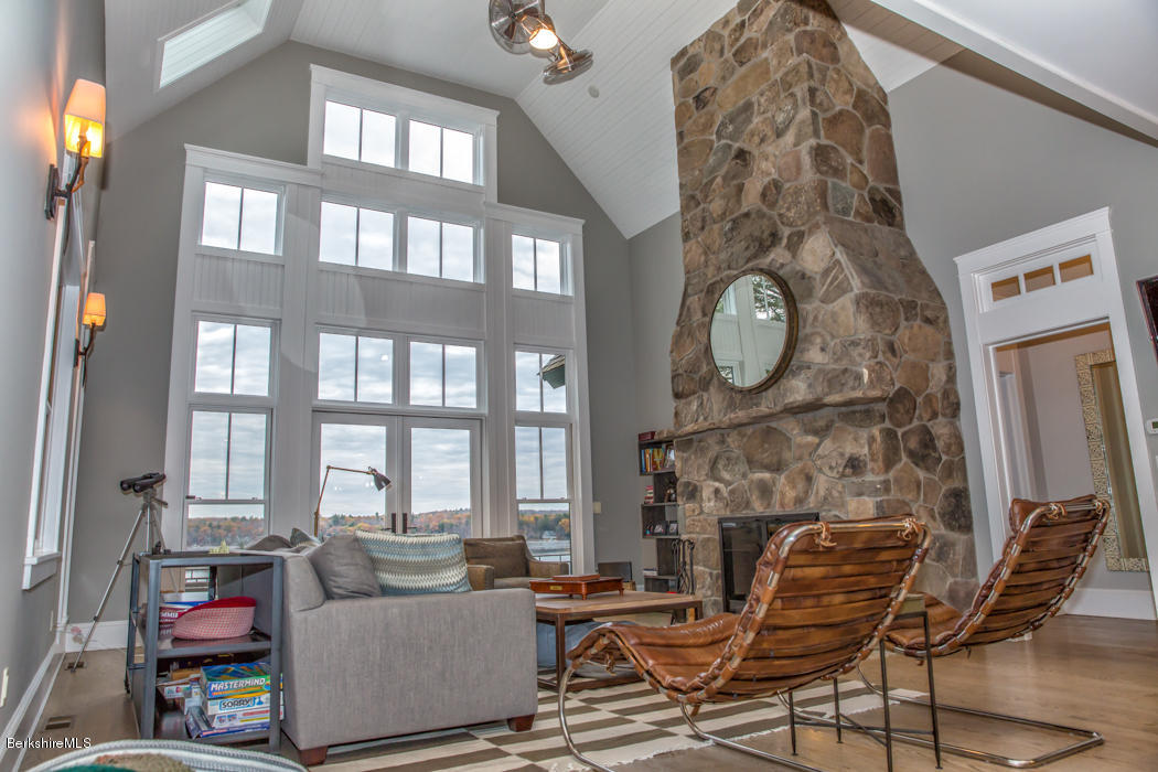 66 Mallard Road Otis, MA 01029 - Photo 6 of 26 a living room with furniture a fireplace and a large window
