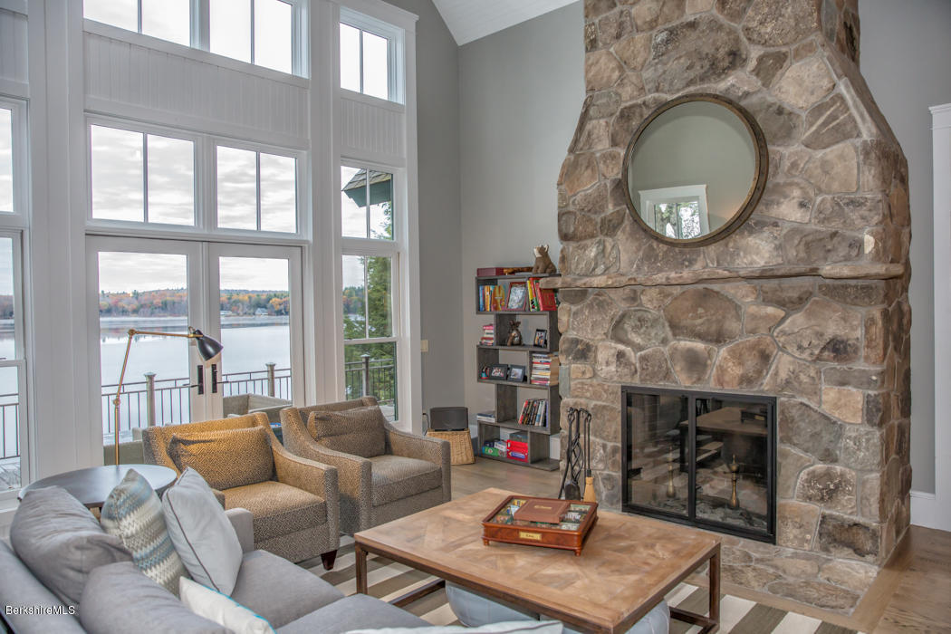 66 Mallard Road Otis, MA 01029 - Photo 7 of 26 a living room with furniture a mirror and a fireplace