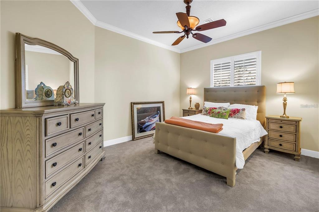 2101 North Pointe Alexis Drive, Unit 1 Tarpon Springs, FL 34689 - Photo 11 of 63 a bedroom with a bed and a dresser in it