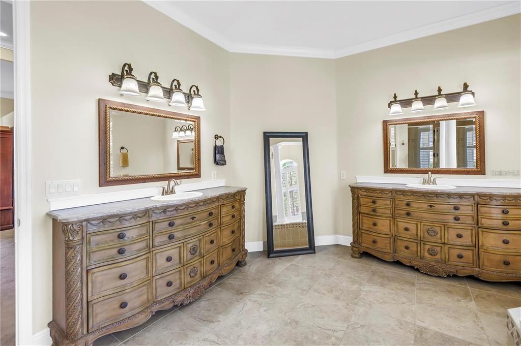 2101 North Pointe Alexis Drive, Unit 1 Tarpon Springs, FL 34689 - Photo 17 of 63 a bathroom with a double vanity sink mirror and