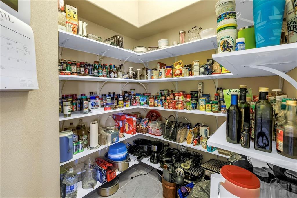 2101 North Pointe Alexis Drive, Unit 1 Tarpon Springs, FL 34689 - Photo 20 of 63 a store room with lots of different colored cloths