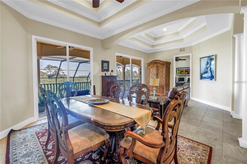 2101 North Pointe Alexis Drive, Unit 1 Tarpon Springs, FL 34689 - Photo 22 of 63 a view of a dining room with furniture window and wooden floor