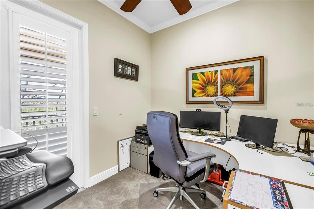 2101 North Pointe Alexis Drive, Unit 1 Tarpon Springs, FL 34689 - Photo 24 of 63 a view of a workspace with furniture and a window