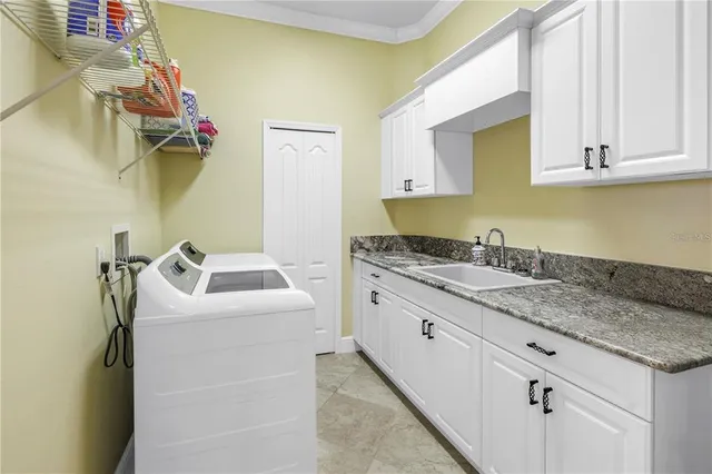 a kitchen with granite countertop a stove a sink dishwasher and cabinets with wooden floor