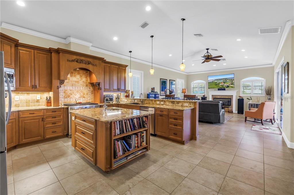 2101 North Pointe Alexis Drive, Unit 1 Tarpon Springs, FL 34689 - Photo 27 of 63 a kitchen with stainless steel appliances granite countertop a stove and a refrigerator