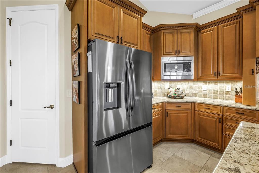 2101 North Pointe Alexis Drive, Unit 1 Tarpon Springs, FL 34689 - Photo 28 of 63 a kitchen with stainless steel appliances granite countertop a refrigerator and a sink