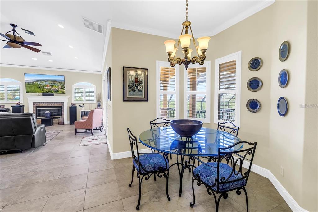 2101 North Pointe Alexis Drive, Unit 1 Tarpon Springs, FL 34689 - Photo 33 of 63 a view of a dining room with furniture and chandelier