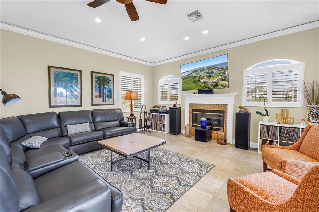 2101 North Pointe Alexis Drive, Unit 1 Tarpon Springs, FL 34689 - Photo 34 of 63 a living room with furniture and a fireplace