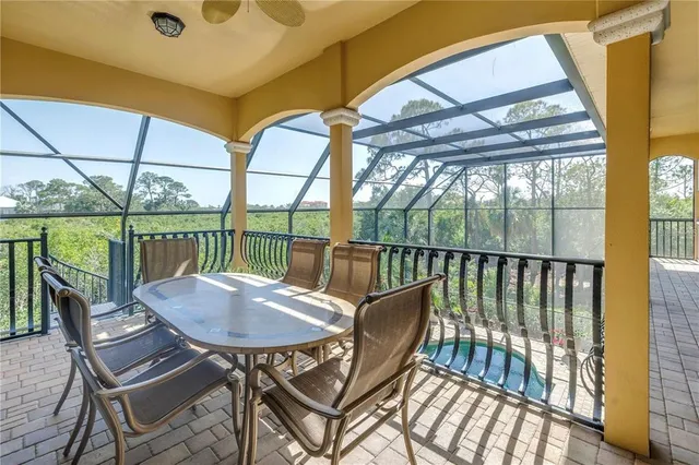 a living room with furniture a flat screen tv and floor to ceiling window
