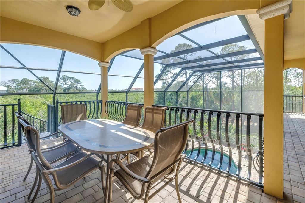 2101 North Pointe Alexis Drive, Unit 1 Tarpon Springs, FL 34689 - Photo 36 of 63 a view of a balcony with furniture and wooden deck