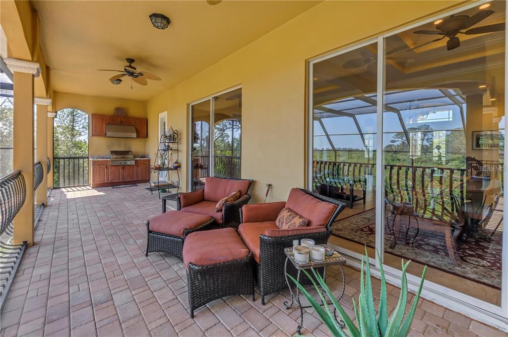 2101 North Pointe Alexis Drive, Unit 1 Tarpon Springs, FL 34689 - Photo 38 of 63 a outdoor space with patio the couch and wooden floor